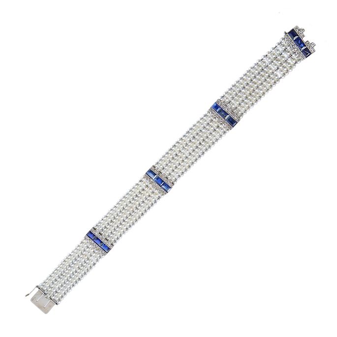 Early 20th century pearl, sapphire and diamond strap bracelet by Cartier, Paris c.1915, formed of a seven row lattice of small pearls, | MasterArt